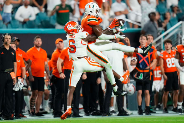Oct 21, 2023; Miami Gardens, Florida, USA; Miami Hurricanes wide receiver Colbie Young (4) makes a catch against Clemson Tigers cornerback Sheridan Jones (6) during the fourth quarter at Hard Rock Stadium. Mandatory Credit: Rich Storry-USA TODAY Sports